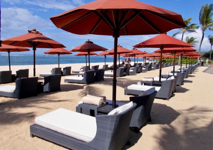 There are plenty of lounge chairs and umbrellas on the beach for guests.