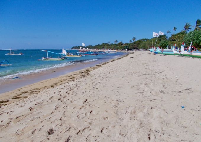 The resort beach has white sand and blue water.