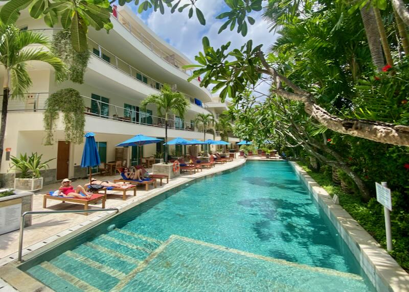 Guests lounge by the pool at Anantara Vacation Club Legian Bali.