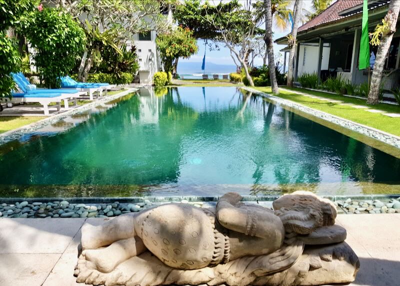 A sculpture of a woman lays next to the pool at Aquaria Eco Resort in Candidasa Bali.