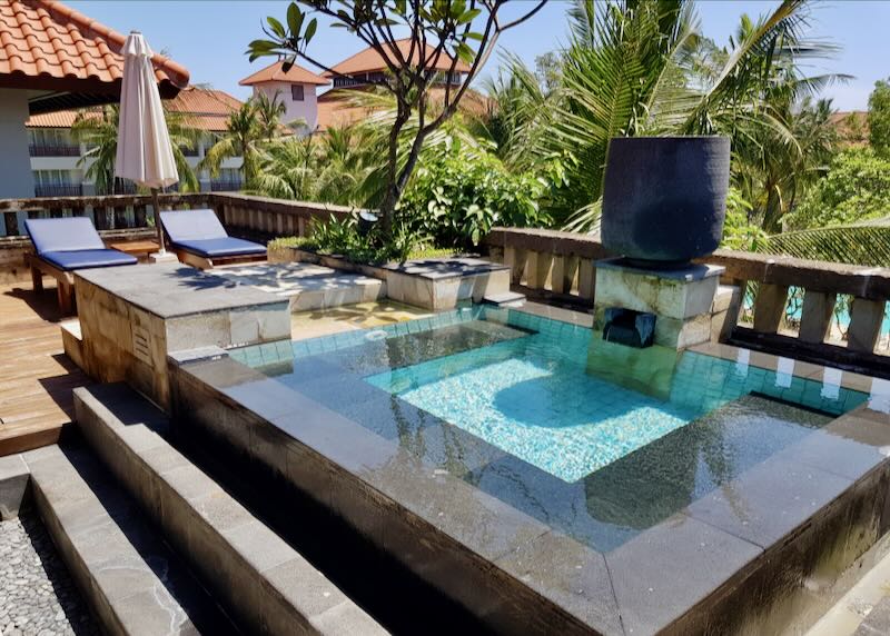 Two chairs sit by a private pool at the Conrad Bali in Tanjung Benoa.