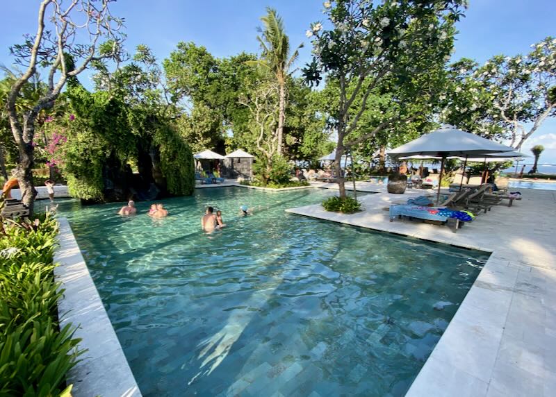 Families play in the pool next to the ocean at the Hyatt Regency Bali in Sanur.