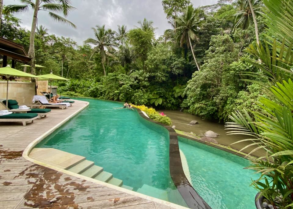 Guests swim in the split-level pool at Four Seasons Sayan in Ubud, Bali.