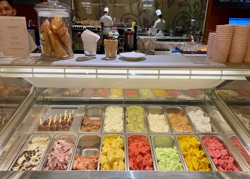 Colorful gelato sits in bins waiting to be scooped.
