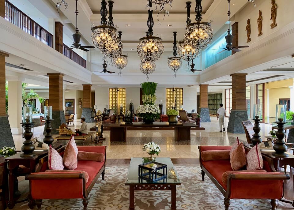 The lobby of the hotel with antique furniture and glass chandeliers.