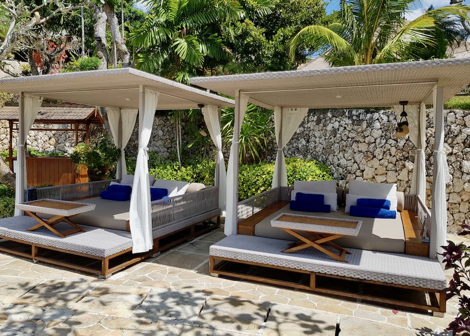 Two large cabanas sit by the pool.