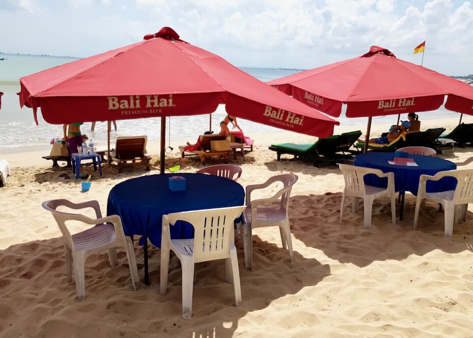 Tables under umbrellas on Muaya Beach.
