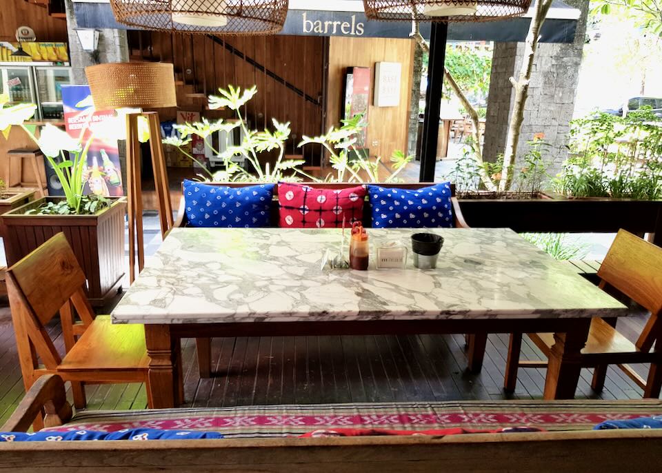 A table at Samasta with colorful cushions.