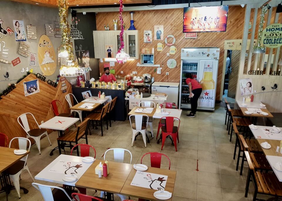 A small restaurant with red and white chairs called Chir Chir.