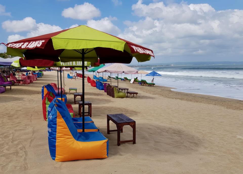 The beach with lots of colorful chairs.