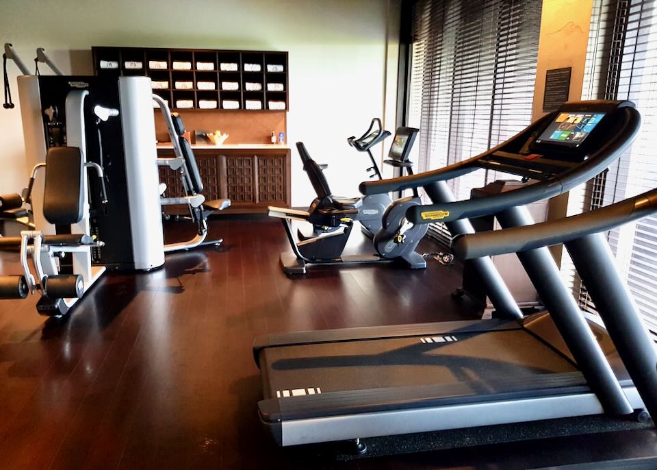 A treadmill and exercise bike sit in the Raffles workout room.