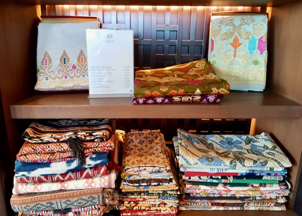 Handmade linens sit on a shelf at the Raffles boutique.