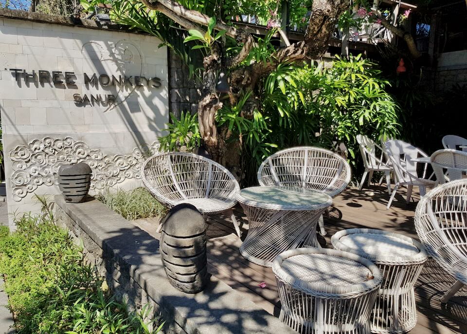 Sun-bleached whicker chairs sit on the patio at Three Monkeys restaurant.