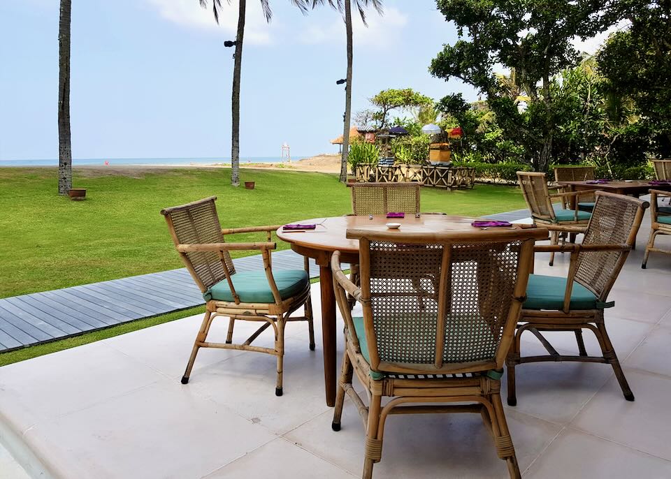An outdoor table sits by the beach.