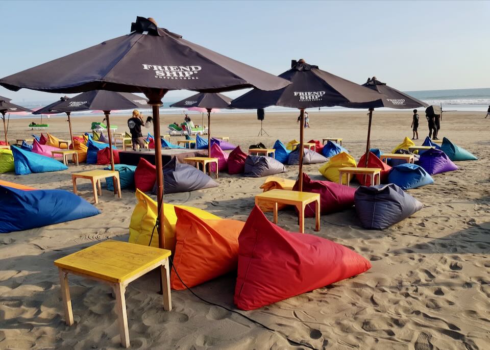 Colorful beanbags sit on the beach.