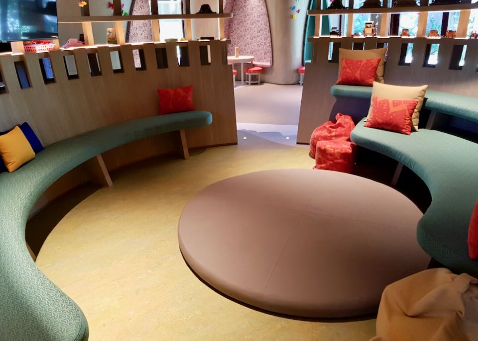 A semi-circle bench sits in a room.