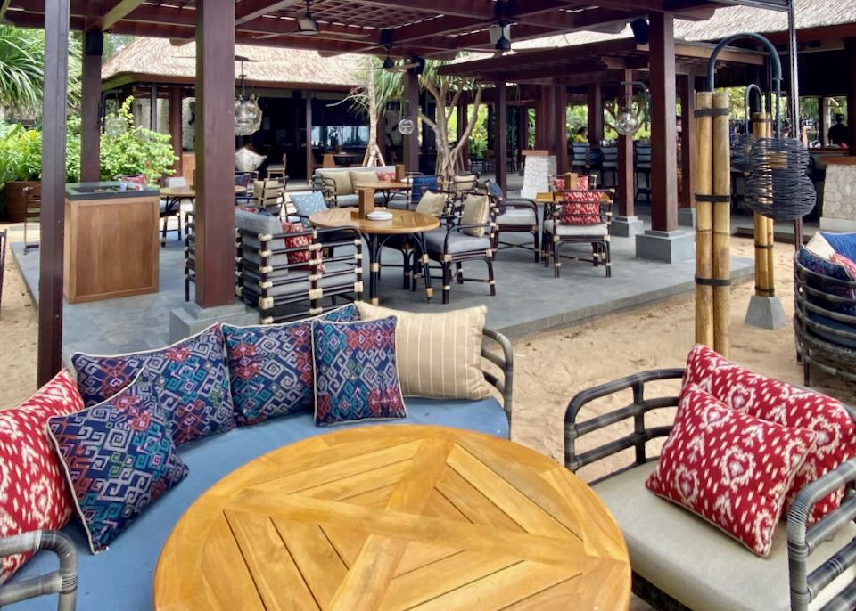 Bright pillows rest on outdoor furniture at the restaurant.