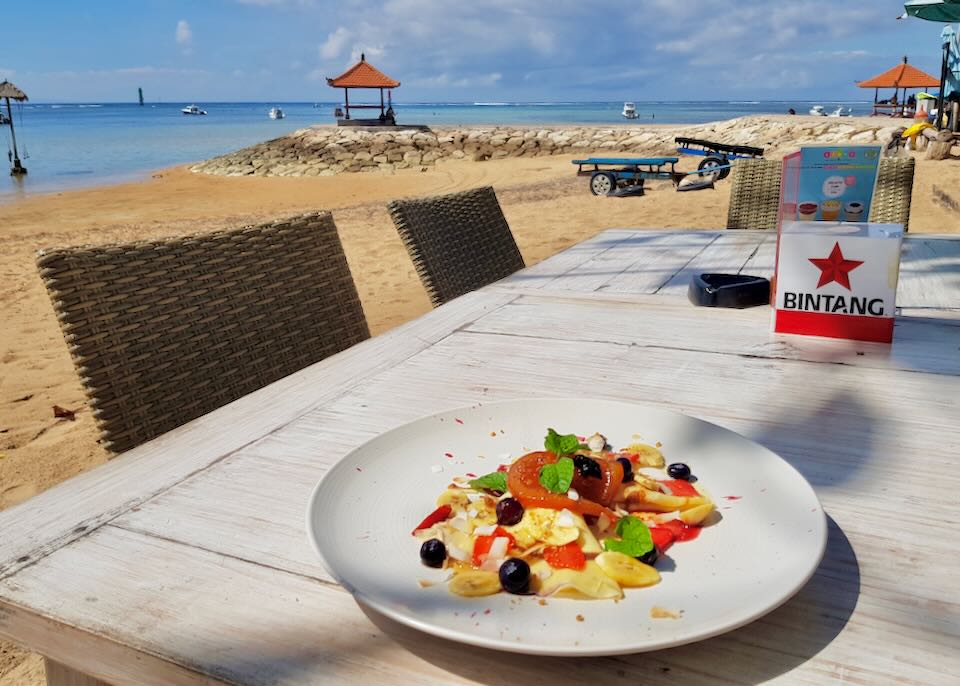 A table of food sits on the beach at TAPHA.
