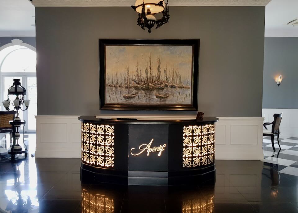 A desk with the words Apéritif lit up on the wood.