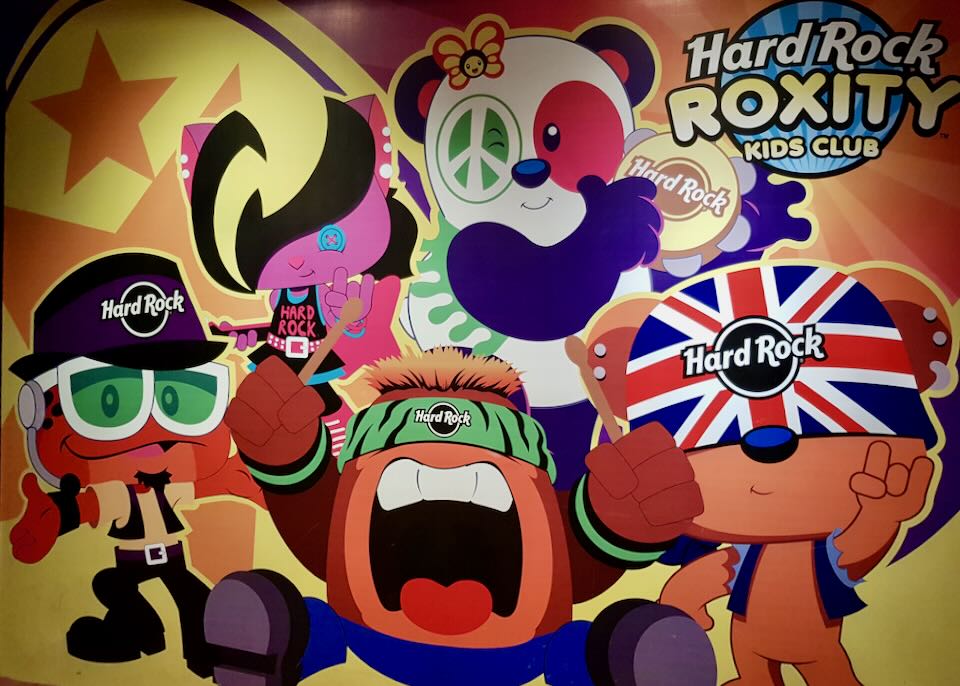 A colorful sign with cartoon characters promotes the Hard Rock Roxity Kids Club.