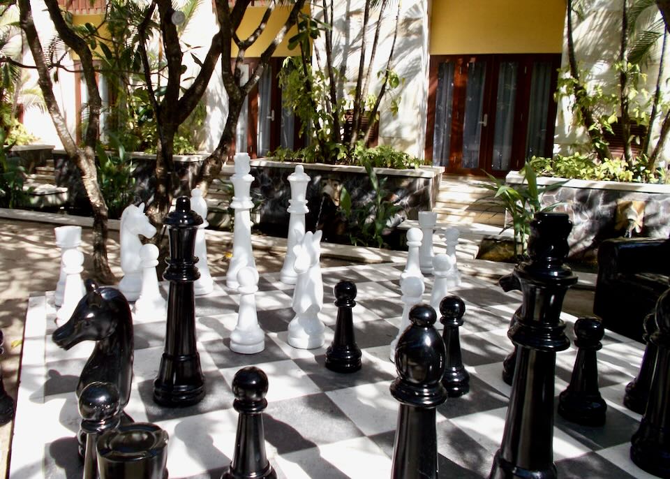 An outdoor large chess game and pieces.