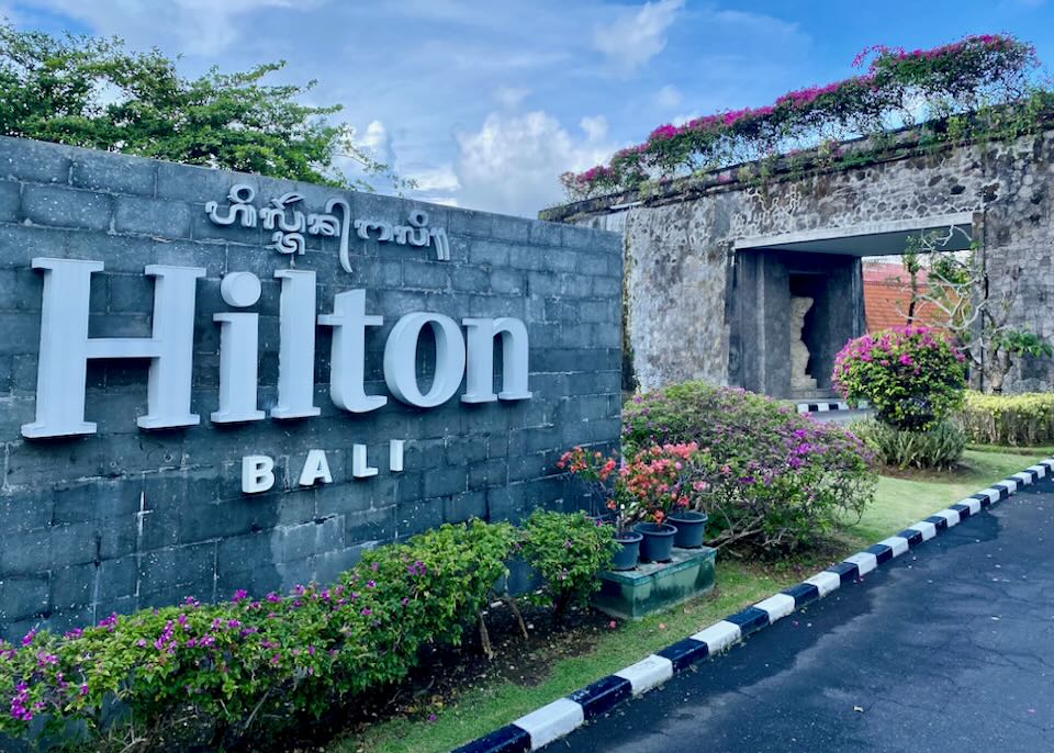 The Hilton sign on a stone wall.