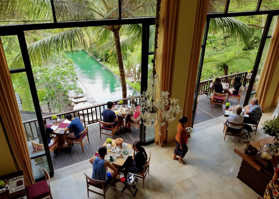 Guest eat at tables that overlook the main pool.