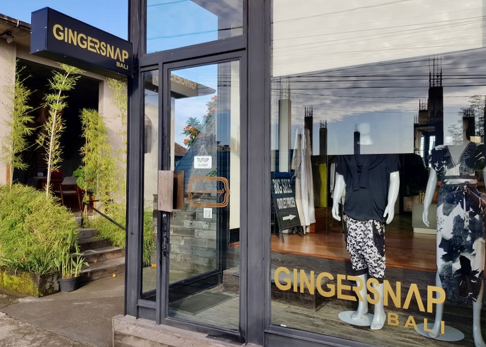 A store window displays a mannequin with clothes by the sign, "Gingersnap Bali."