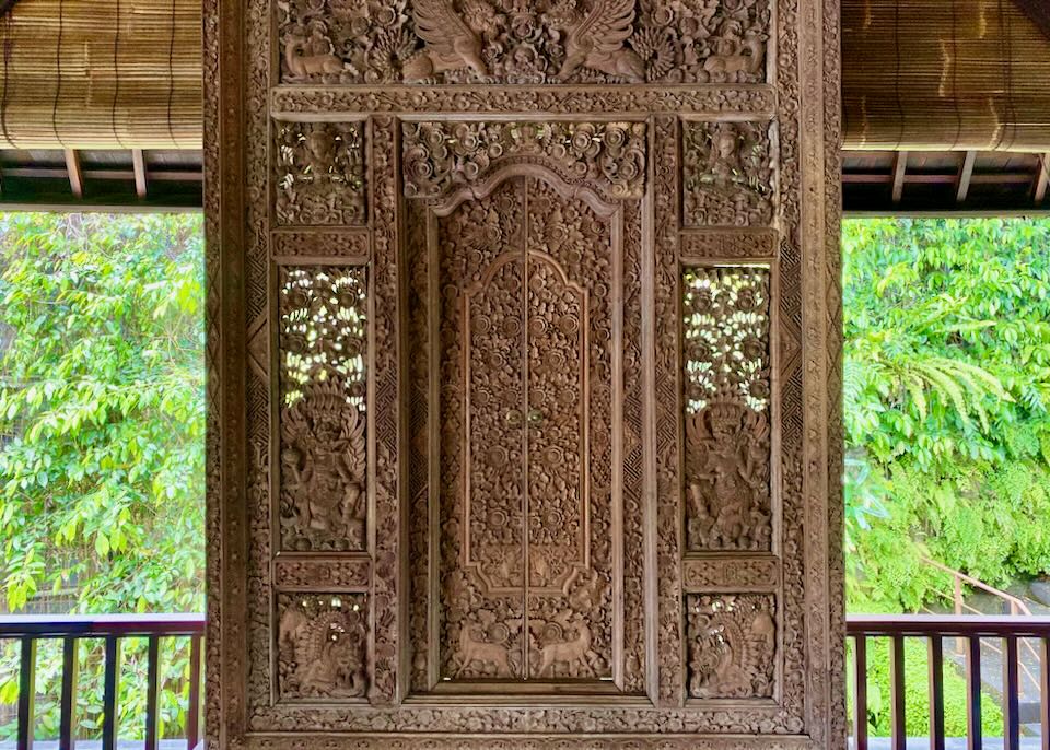 A old carved wood door is displayed in the lobby.