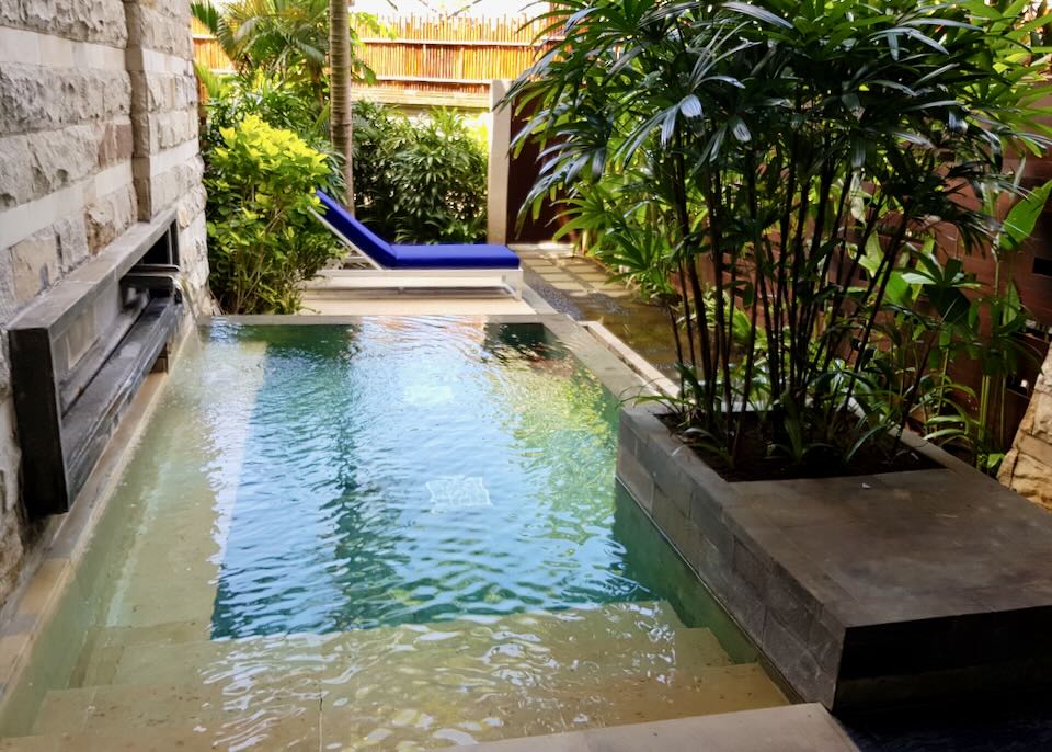 A small private pool with a fountain.