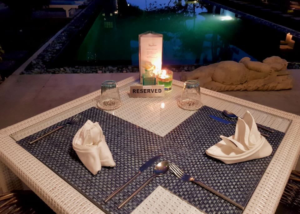 A table with a reserved sign sits next to the pool.