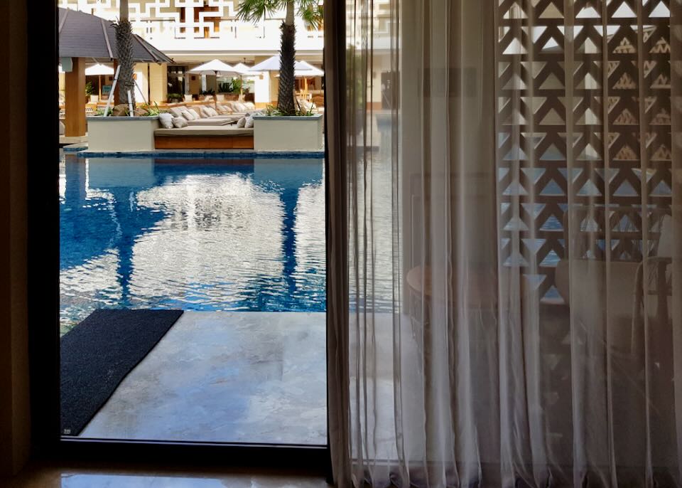 At ground level, the patio from the room leads into the pool.