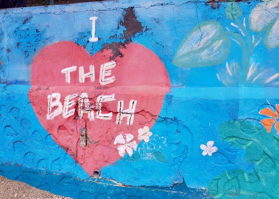 A mural with a heart and text that reads, "I heart the beach."
