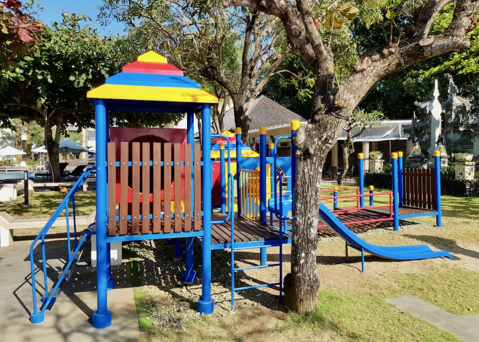 Bright blue, red, and yellow slides and playground equipment.