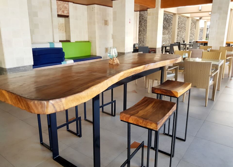 A raw-edge table and chairs sits in a restaurant.