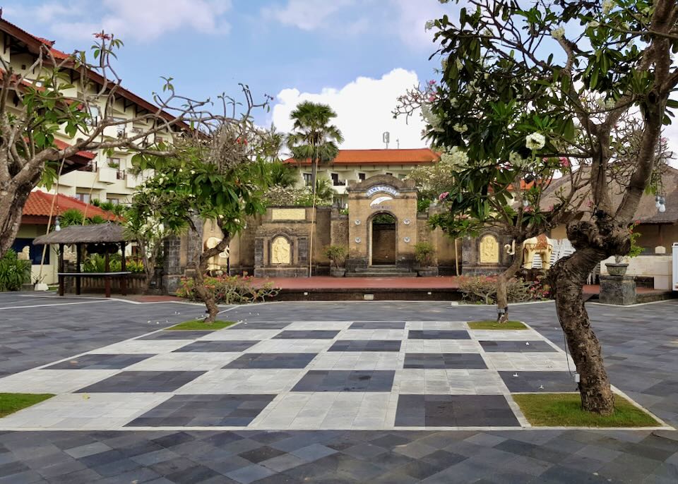 A white and black checkered section of tile sits in a courtyard.