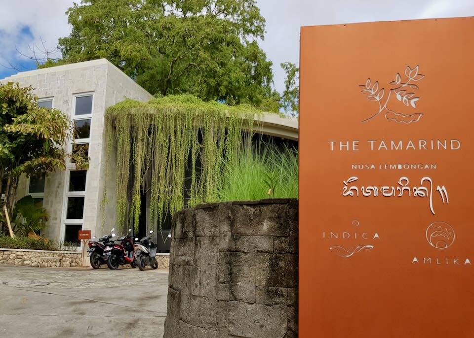 An orange sign outside the hotel that reads, "The Tamarind, Nusa Lembongan."
