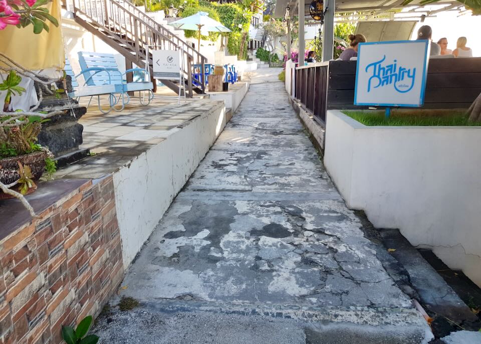 A cement walkway by some cafes.