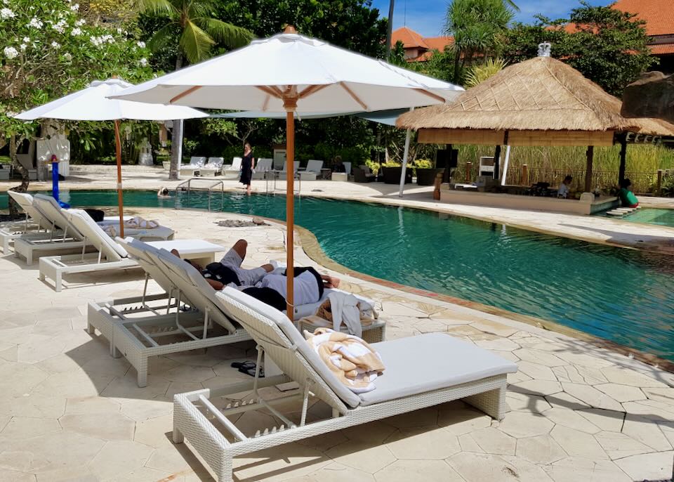 Guest lay on lounges by the pool.