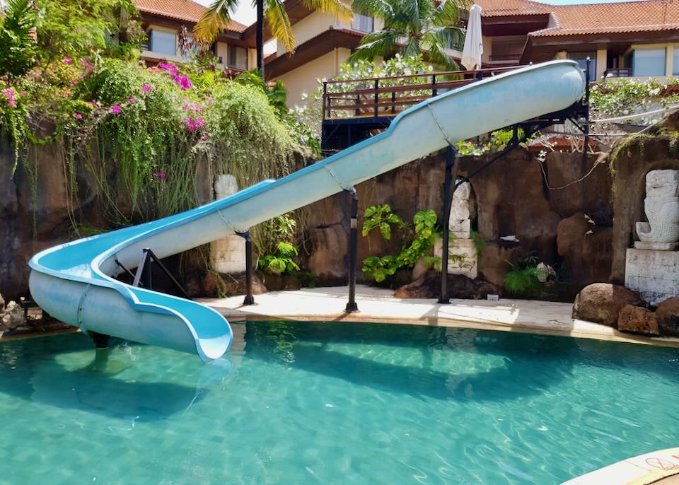 A waterslide empties into a pool.