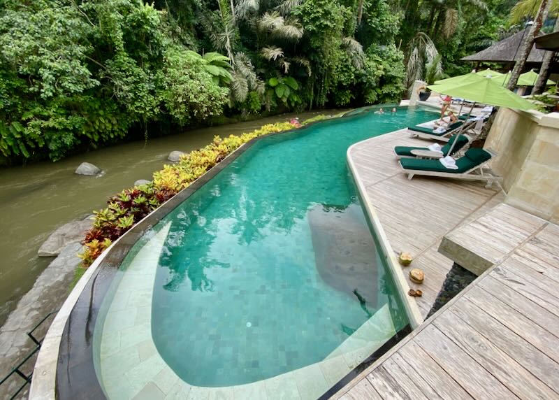 A pool sits next to a river.
