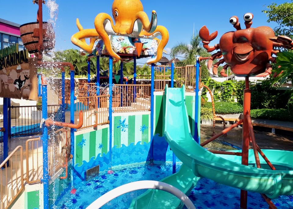 colorful sculptures of crabs sit above the kids pool.