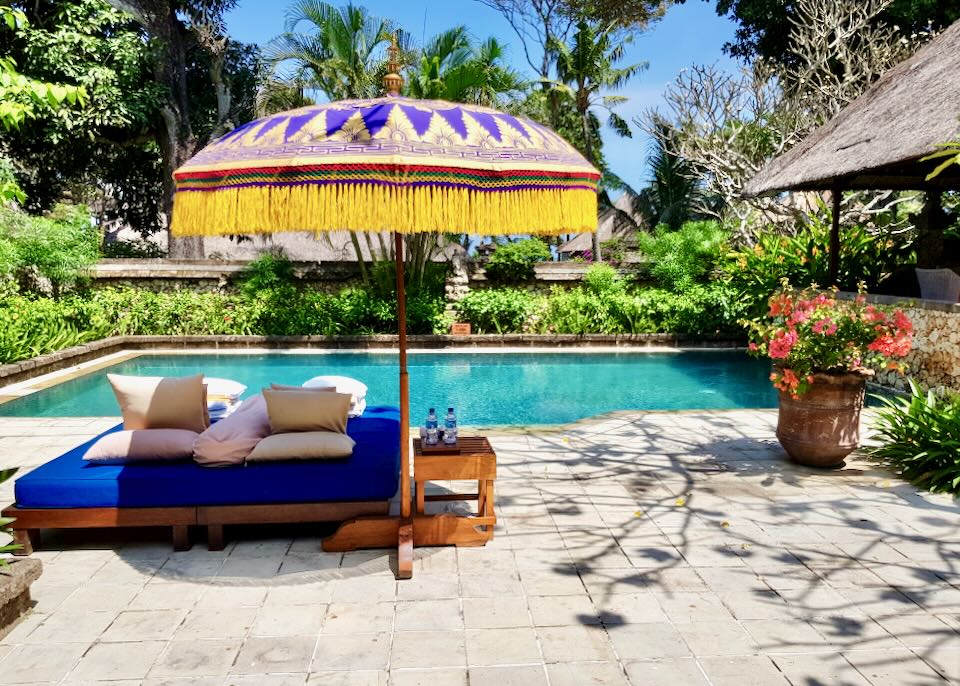 A lounge chair sits next to the private pool at the Oberoi Beach Resort, in Bali.
